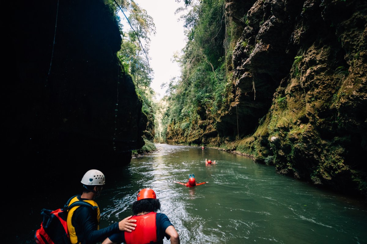 A group navigates the underground Tanama River in Utuado.