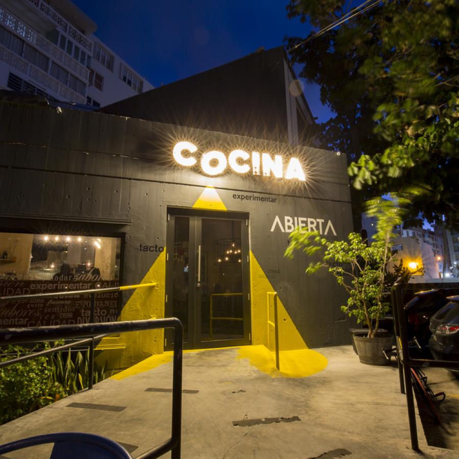 The exterior of Cocina Abierta restaurant in San Juan at night.