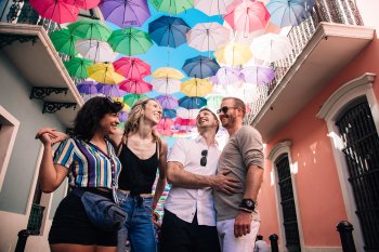 Two couples laugh on the street in old san juan.