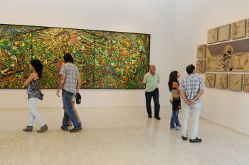 People view an art exhibit at the Museo de Arte de Bayamon.