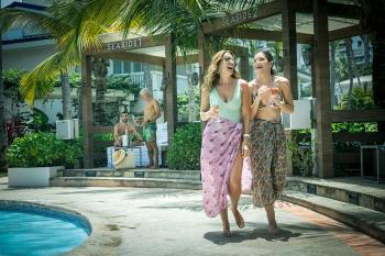 Two ladies enjoy their cocktails by the pool at Fairmont El San Juan hotel.