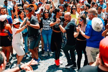 A large group of people salsa in the streets of Old San Juan, Puerto Rico