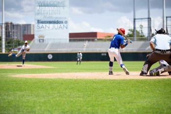 A batter stands at the plate prepared to swing during a baseball game in Puerto Rico.