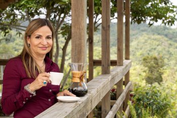 Woman drinking coffee in a coffee hacienda.