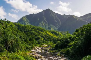 A stunning mountain landscape in Utuado, Puerto Rico, with the dramatic rock formations of Canon Blanco in the foreground.