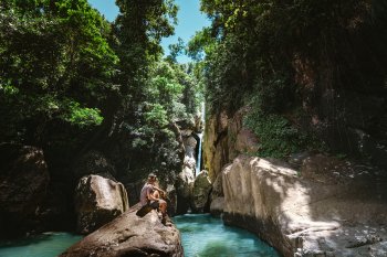 Man in front of waterfall.