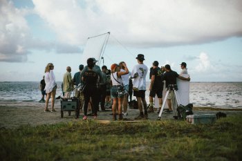 Group filming at the beach.