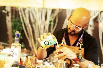 Bartender Israel Bravo mixing drinks.