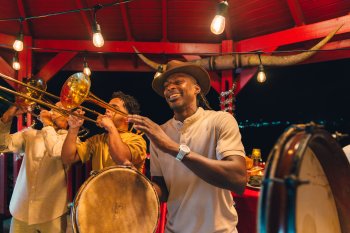 A group of people playing tambourines and the trumpet.