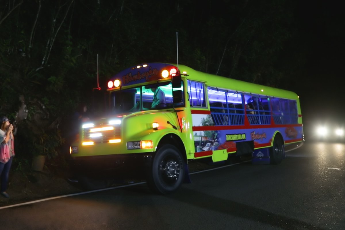 A vibrant Chinchorreo bus waits for its passengers to finish up at their latest stop.