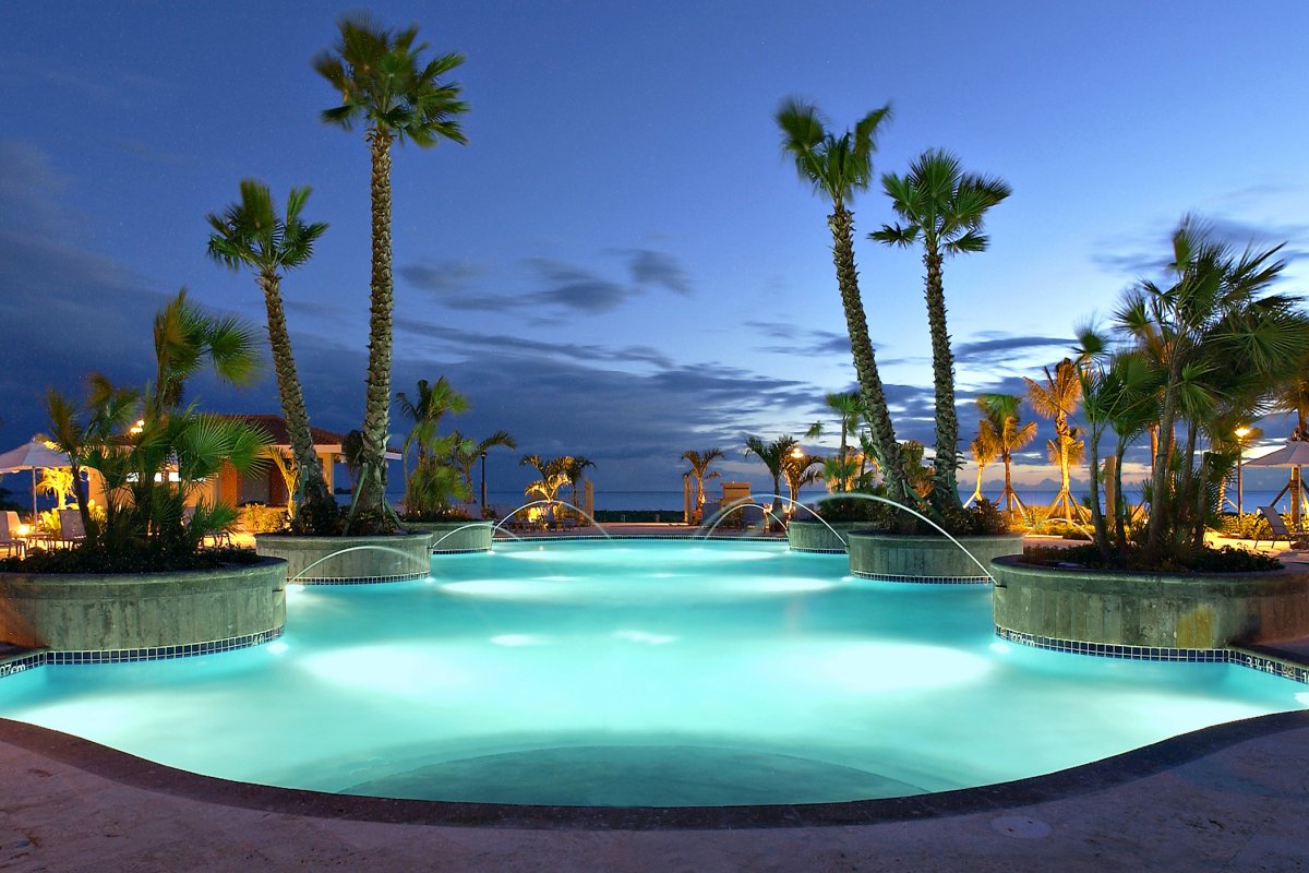 The pool at Hilton Ponce Golf & Casino Resort, lit up at night.