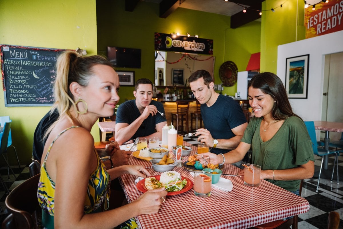 A group samples food on a Spoon Food Tour.