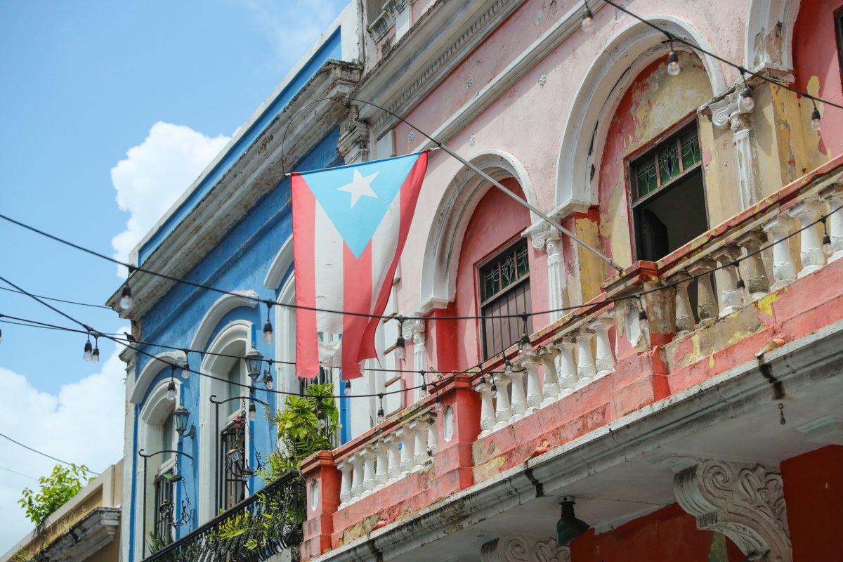 A Puerto Rican flag waves on an Old San Juan street.