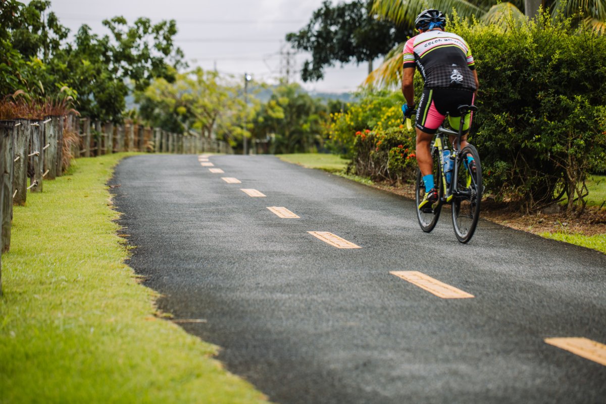 a guy riding a bike along a trail in bayamon