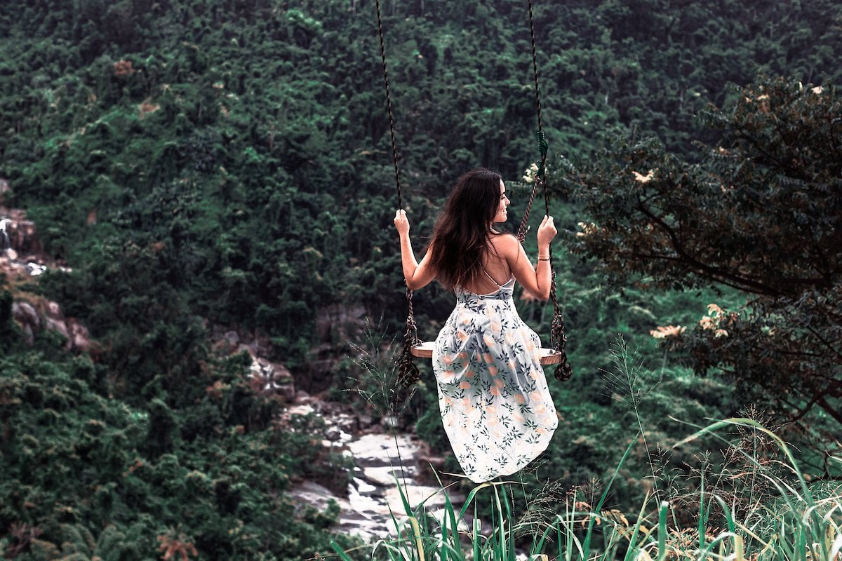 A woman swings from Columpio de los Suspiros in Naguabo