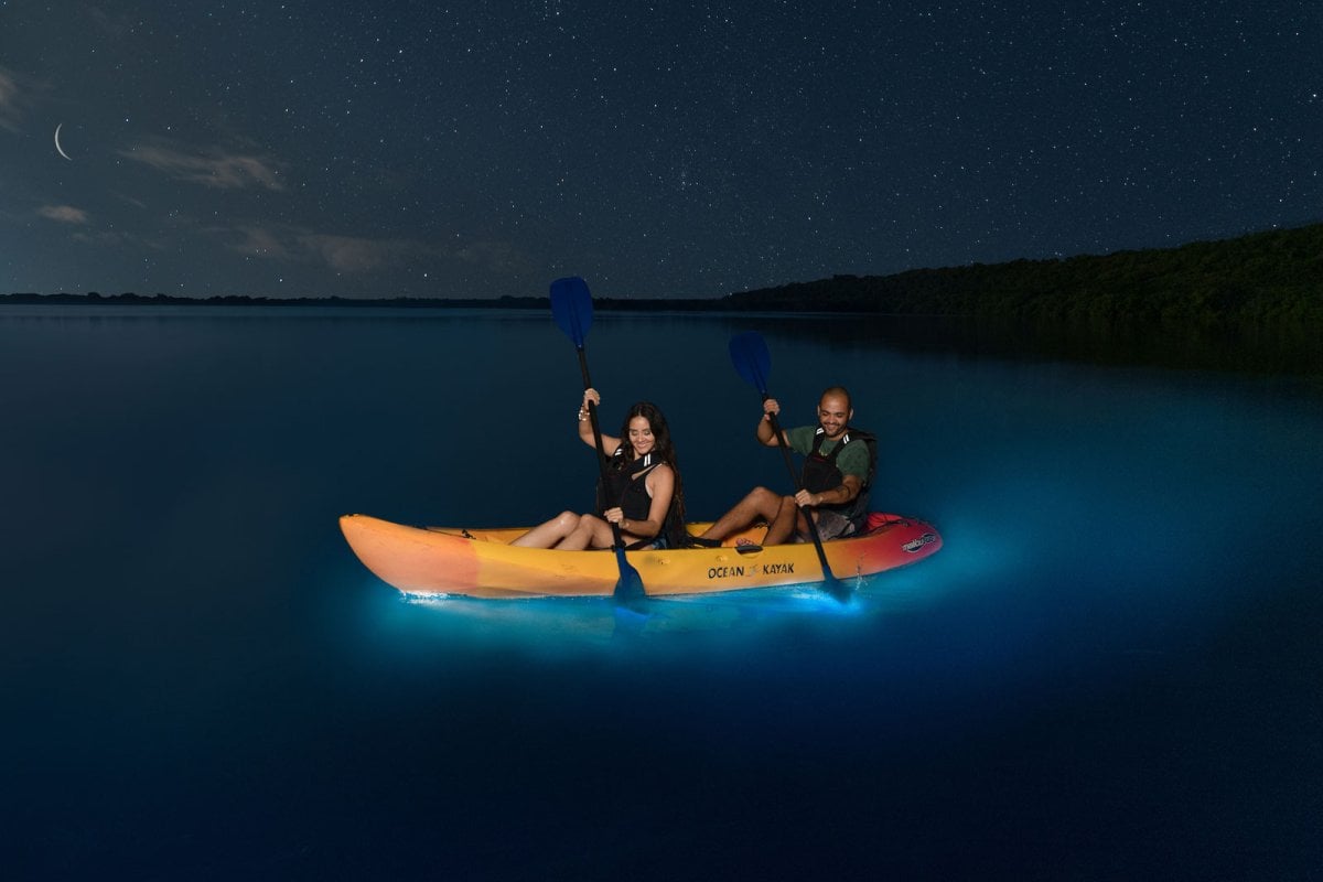 A pair of kayakers paddle through Laguna Grande, a bioluminescent bay in Fajardo, Puerto Rico.