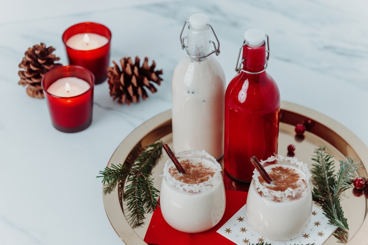 Bottles and glasses filled with coquito.