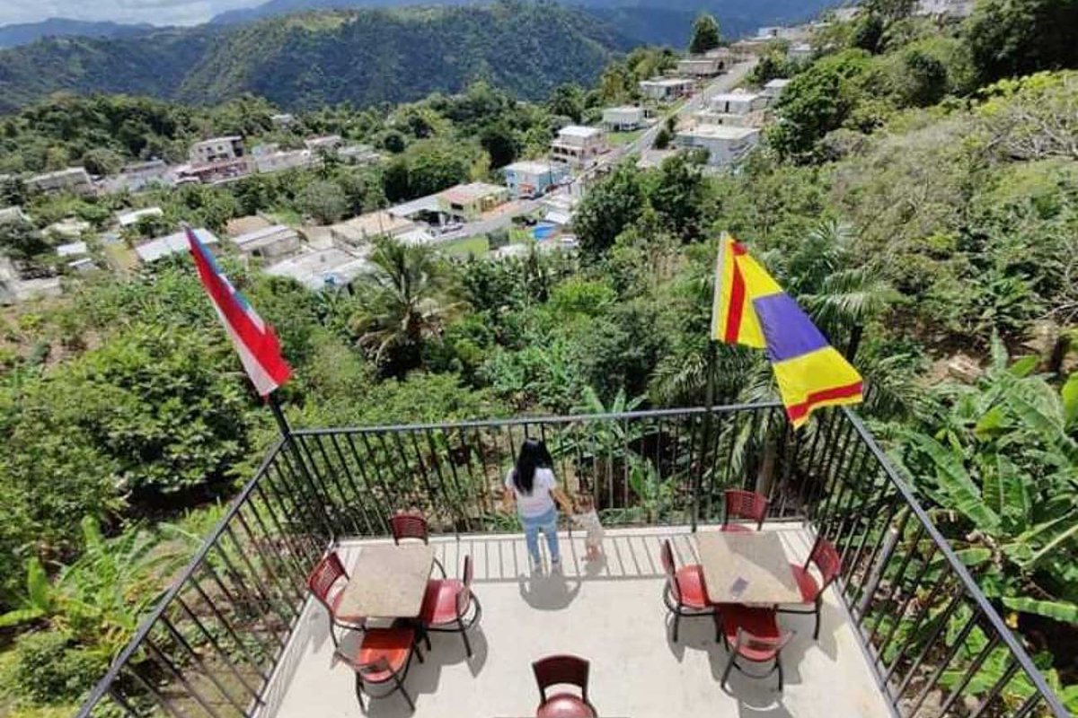 A woman and a young child stand on the rooftop of El Caney, a restaurant in Ciales, Puerto Rico.