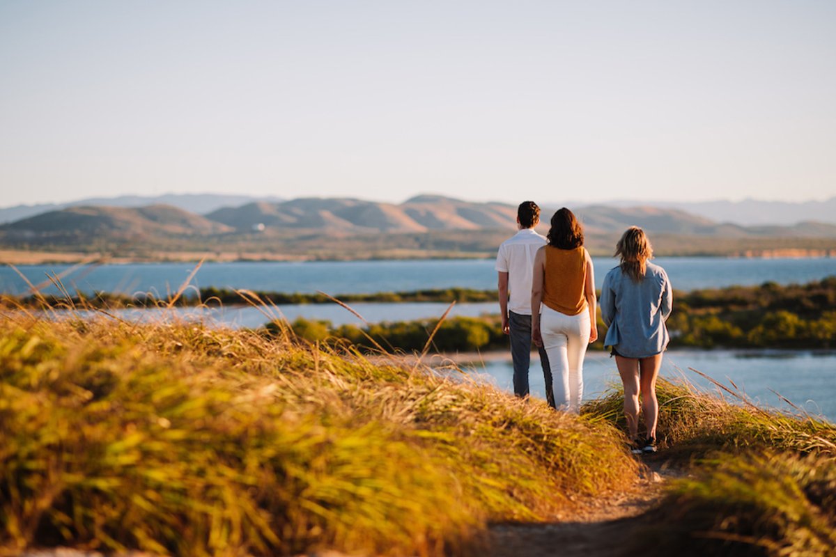 Father, mother and daughter hiking the trails that surround Los Morrillos Lighthouse in Cabo Rojo, Puerto Rico.