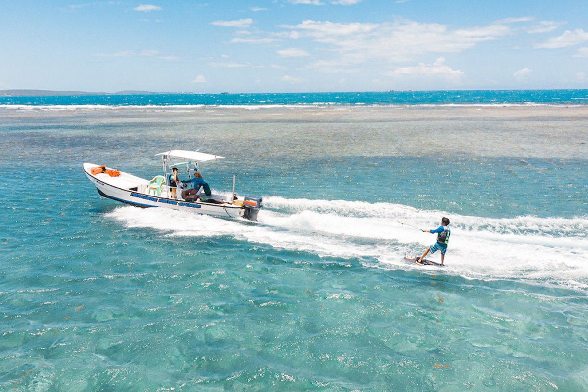 Young man wakesurfing in the crystal-clear waters of La Parguera in Puerto Rico.