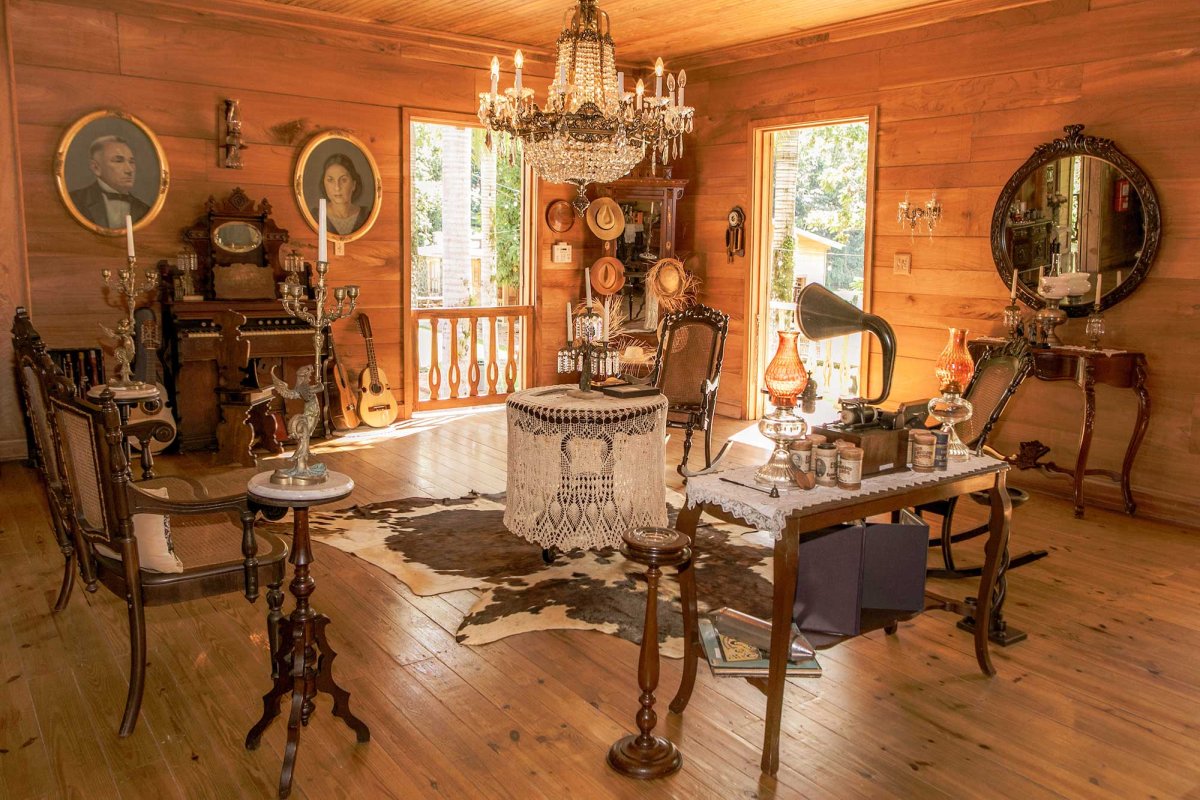 An opulent chandelier and Victorian-era furnishings fill a wood-paneled room at Hacienda Lealtad, a 19th-century coffee plantation in Lares, Puerto Rico.