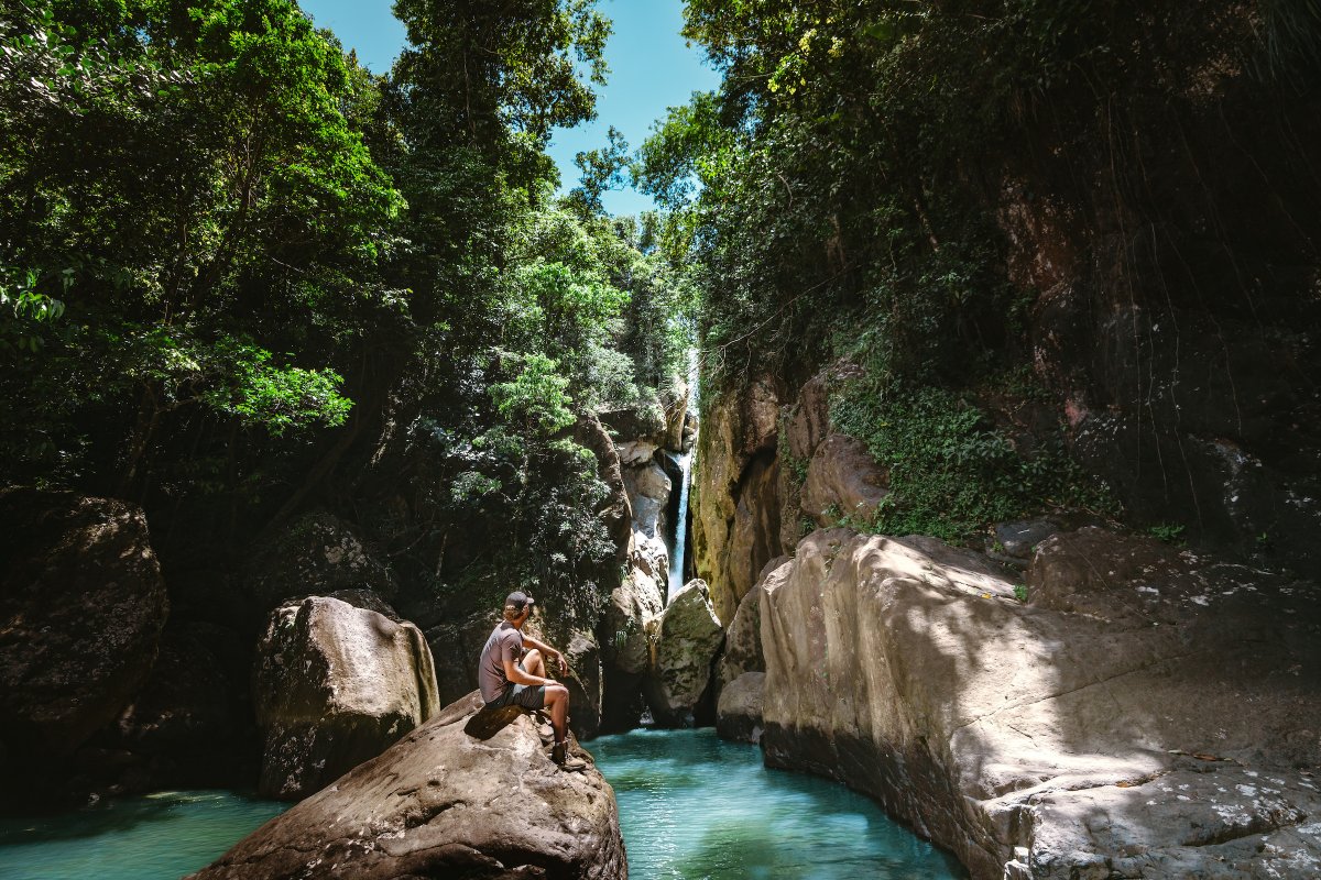 Man in front of waterfall.