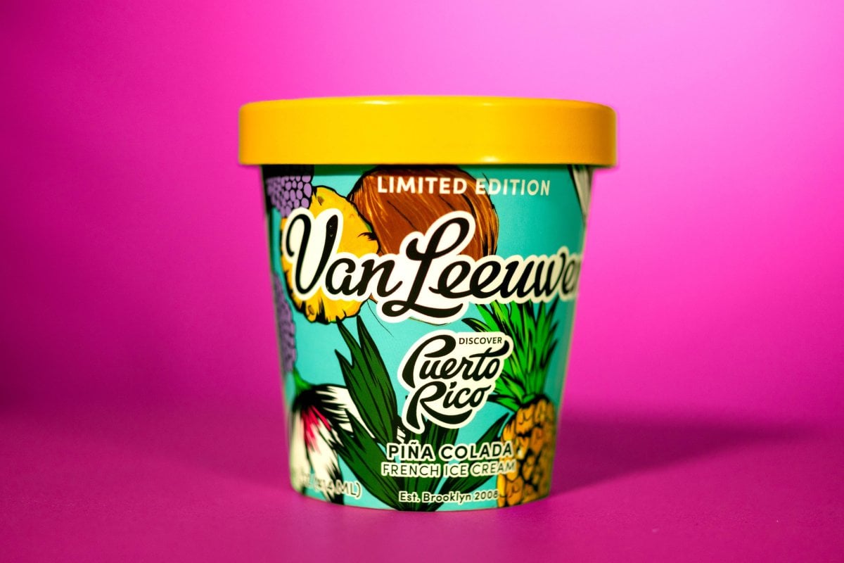 A Van Leeuwen pint of Piña Colada ice-cream in front of a vibrant backdrop.