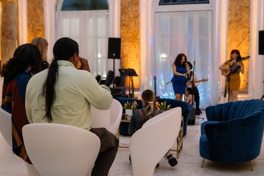 A small string quartet playing in a intimate gathering.