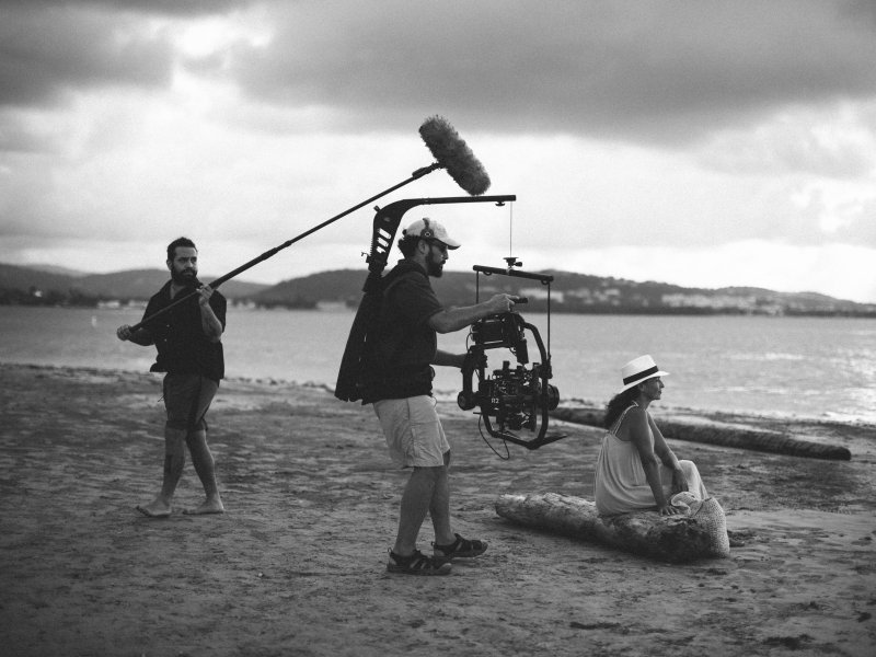 Film crew in the beach.