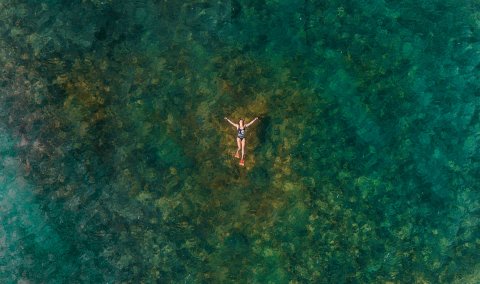 A woman enjoys a warm day in the ocean at Cabo Rojo.