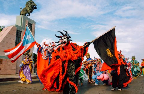 Revelers in traditional vejigante costumes at Carnaval Ponceño.