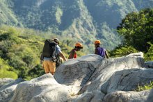 Group of people hiking around a natural rock formation