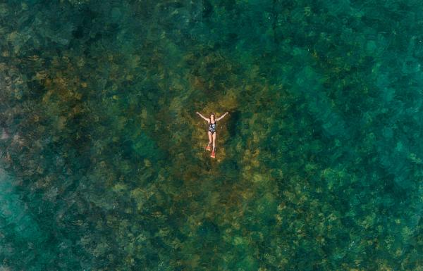 A woman enjoys a warm day in the ocean at Cabo Rojo.