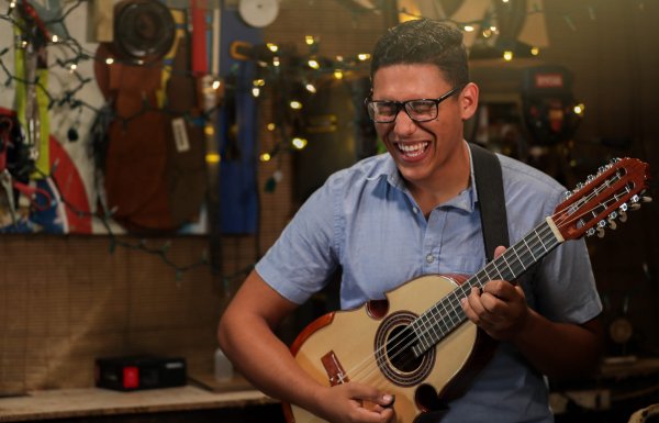 a man playing the cuatro, Puerto Rico's national instrument. 