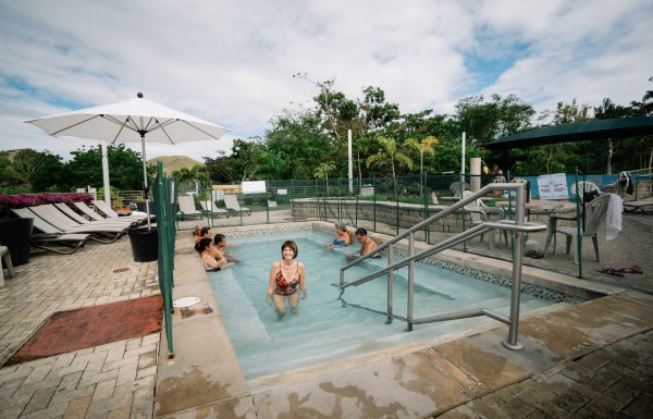 A woman gets out of the hot spring pool