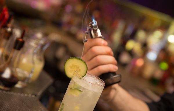 A bartender prepares an elaborate craft cocktail at Gallo Negro.