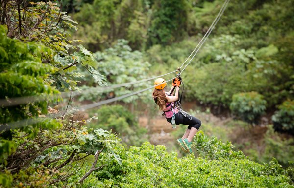 Woman ziplines down a rail at Toro Verde in Orocovis