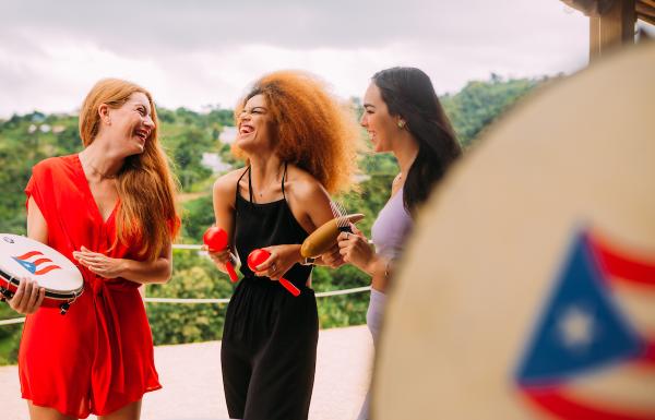 Girls are singing and laughing during a holiday parranda. 