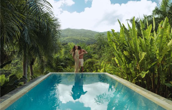 A couple embraces at the edge of an infinity pool in Rio Grande, Puerto Rico