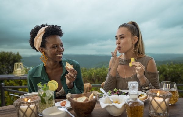 Two women share a meal at an outdoor restaurant in Puerto Rico