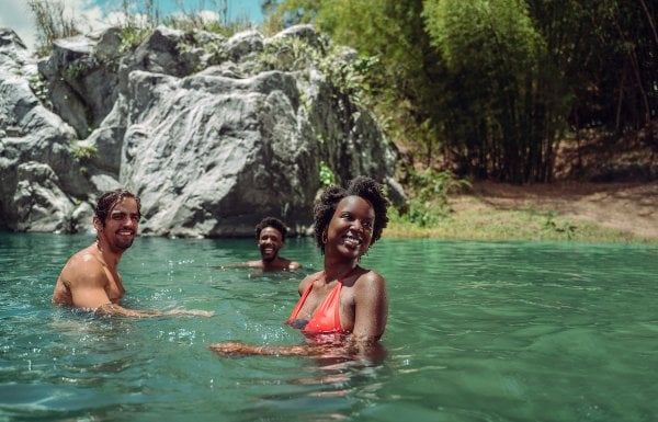 a family enjoys the river in Puerto Rico