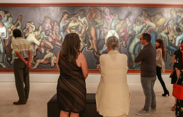 People admire a great painting in a museum