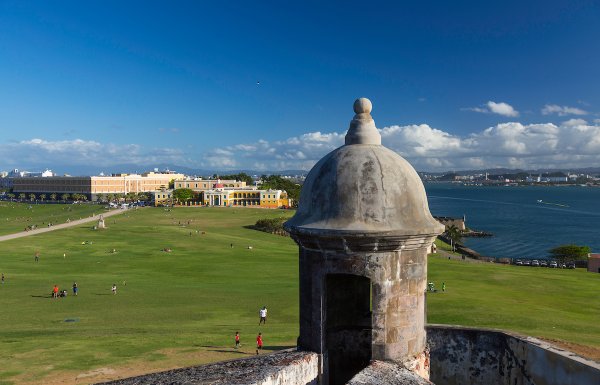 People approaching Castillo San Felipe del Morro in historic San Juan on a sunny day. 