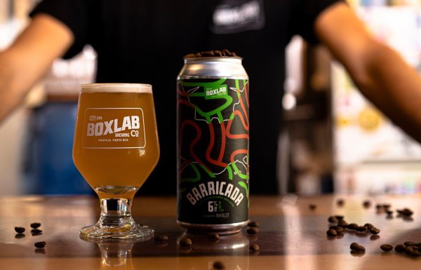 A glass of beer and can of Box Lab Beer