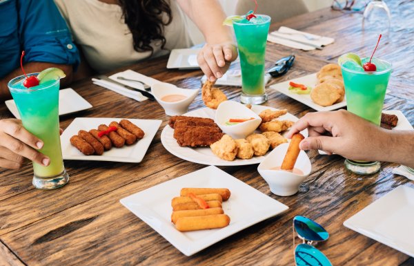 Dinner table filled with appetizers and drinks.