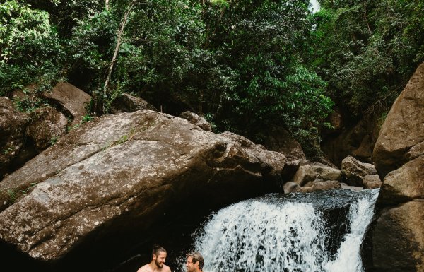 Two men in a waterfall at El Yunque.