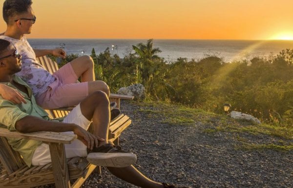 Couple sitting on beach chairs overlooking the beach.