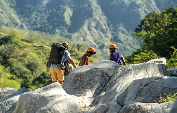 Group of people hiking around a natural rock formation