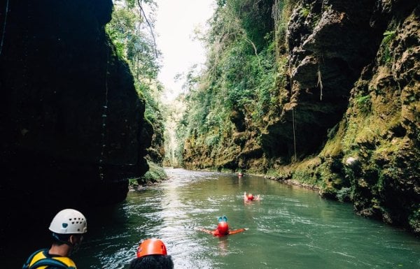 Group of people floating down a river.