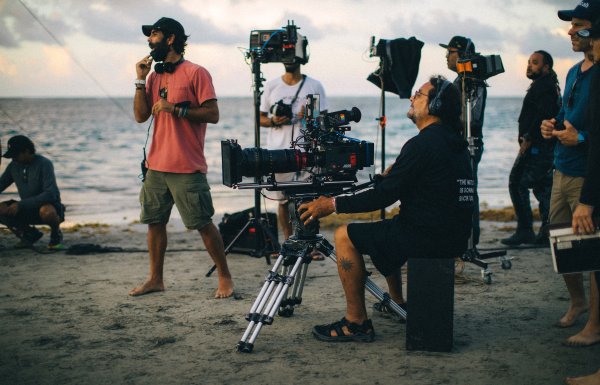 Film crew in the beach.